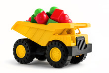 Yellow Dump Truck Toy With Colorful Plastic Blocks On White Background