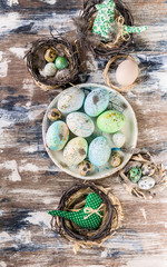 Wall Mural - Easter eggs on a plate and in a small nest on colorful surface. Vertical shot