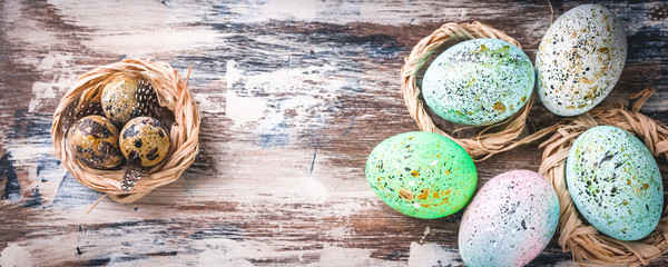 Wall Mural - Easter banner. Easter eggs in nests. Rustic surface. Vertical shot