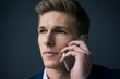 © Westend61 - Portrait of young businessman on cell phone