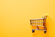 Shopping Concept. Shopping Cart On A Yellow Background.