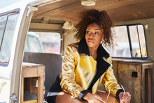 Stylish Edgy African American Woman Wearing Golden Jacket And Sunglasses In Old Van