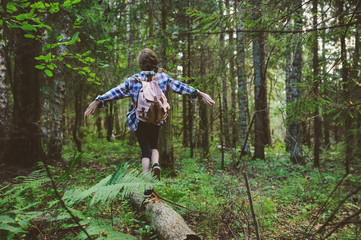 happy kid girl exploring summer forest, traveling on vacation. Teaching kids to love nature. Earth day concept.