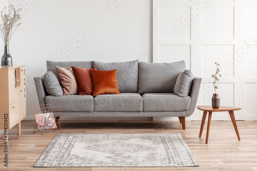 Orange Red And Beige Pillows On Grey Comfortable Couch In Chic
