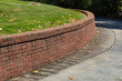 Residential brick retaining wall, curved along driveway, horizontal aspect