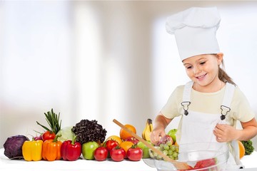 Poster - Portrait of adorable little girl preparing healthy food at kitchen