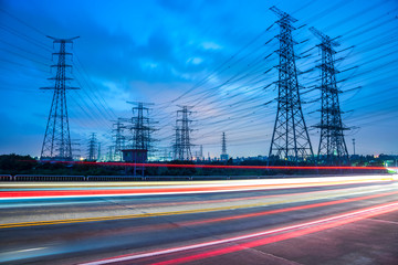 Wall Mural - High voltage, high speed road car track in the background of high voltage towers