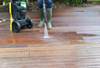 © coco - woman washing wooden terrace with high pressure water