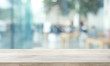 © hakinmhan - Wood table top on blur window glass,wall background with city view.For montage product display or design key visual