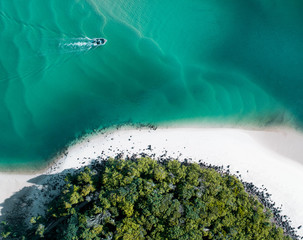 Wall Mural - Beach aerial summer with boat and blue tropical water. Beautiful gold coast hot drone shot with boat and sand drift.