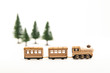 Golden wooden toy train isolated from white background and blur pine tree