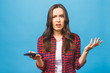 © denis_vermenko - Portrait of a furious caucasian woman talking on mobile phone isolated over blue background. Negative emotions.