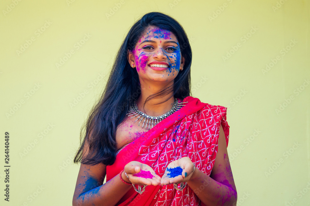 Holi Festival Of Colours. Portrait of happy indian girl in traditional  hindu sari on holi color .