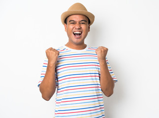 Happy young asian man celebrates with two hand in the air on isolate white background.