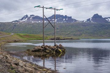 Canvas Print - Electricity pylon on the shore of Fjord Berufjordur in eastern Iceland