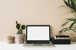 canvas print picture Minimalist home office desk workspace with laptop, cactus, palm on beige background. Front view copy space blank mock up. Freelancer business template.