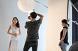 © Blue Jean Images - Photographer taking picture of model in studio