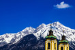 church spires with alpine mountain background