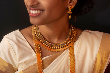 Young girl in traditional Kerala saree and jewelry.