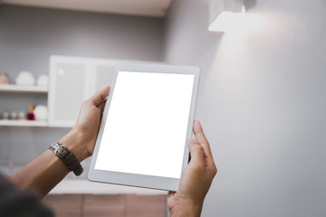 Wall Mural - Mockup tablet on businessman hands empty display on home table with blur background. - Image - Image
