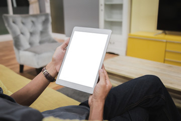 Wall Mural - Mockup tablet on businessman hands empty display on home table with blur background. - Image - Image