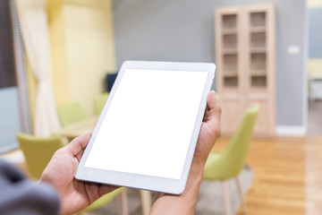 Wall Mural - Mockup tablet on businessman hands empty display on home table with blur background. - Image - Image