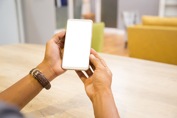Wall Mural - Mockup smartphone on businessman hands empty display on home table with blur background. - Image - Image
