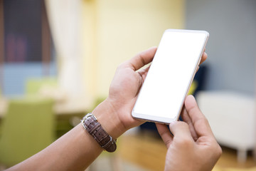 Wall Mural - Mockup smartphone on businessman hands empty display on home table with blur background. - Image - Image