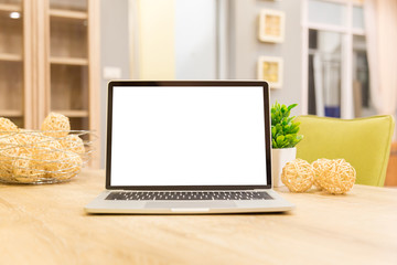 Wall Mural - laptop showing blank screen on work table front view in home- Image