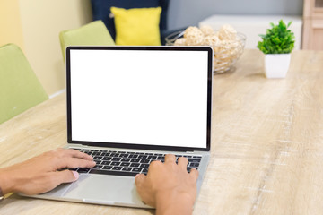 Wall Mural - Mockup image of a businessman using laptop with blank white desktop screen working in home- Image