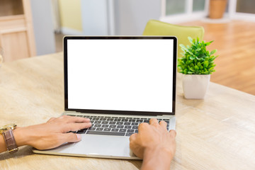 Wall Mural - Mockup image of a businessman using laptop with blank white desktop screen working in home- Image