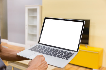 Wall Mural - Mockup image of a businessman using laptop with blank white desktop screen working in home- Image