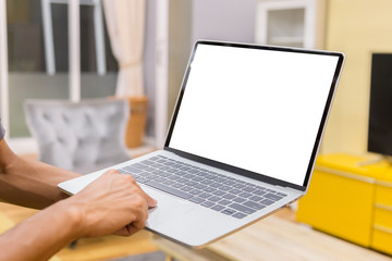 Wall Mural - Mockup image of a businessman using laptop with blank white desktop screen working in home- Image