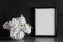 Fresh Bouquet Of White Lilac Flowers In Vase On Shelf At Black Wall. Condolence Concept. Empty Place For Emotional, Sentimental Text, Quote Or Photo In Frame. Front View. 