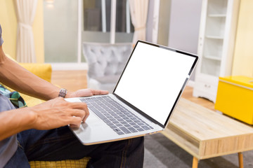 Wall Mural - Mockup image of a businessman using laptop with blank white desktop screen working in home- Image