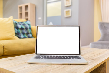 Wall Mural - laptop showing blank screen on work table front view in home- Image