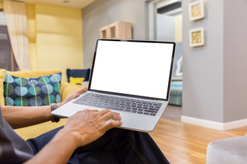 Wall Mural - Mockup image of a businessman using laptop with blank white desktop screen working in home- Image