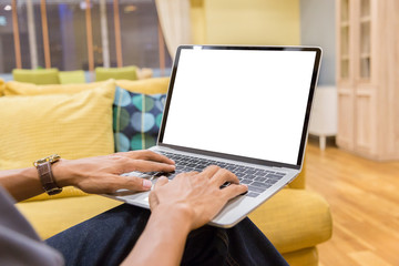 Wall Mural - Mockup image of a businessman using laptop with blank white desktop screen working in home- Image