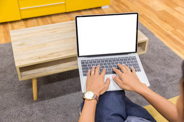 Wall Mural - Mockup image of a businessman using laptop with blank white desktop screen working in home- Image