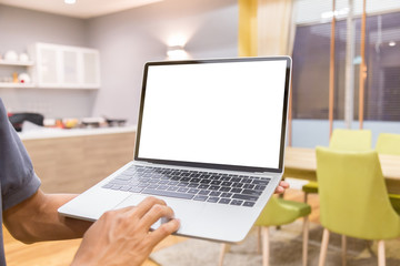 Wall Mural - Mockup image of a businessman using laptop with blank white desktop screen working in home- Image