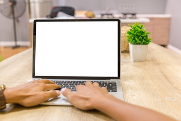 Wall Mural - Mockup image of a businessman using laptop with blank white desktop screen working in home- Image