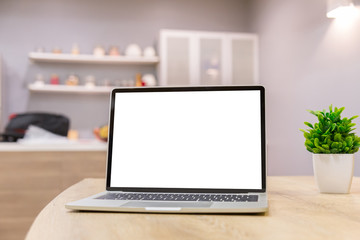 Wall Mural - laptop showing blank screen on work table front view in home- Image