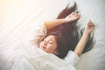 Wall Mural - Beautiful young woman sleeping on bed at bedroom