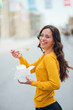 © bnenin - Young woman walking in the city and eating takeaway lunch.