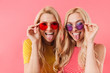 Funny blonde twins in sunglasses having fun