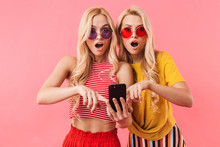 Shocked Blonde Twins In Sunglasses Using Smartphone