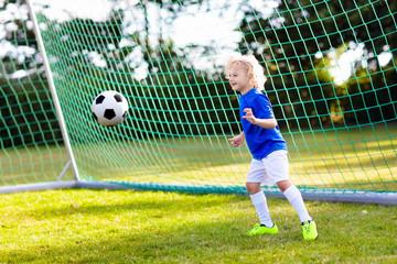 Poster - Kids play football. Child at soccer field.