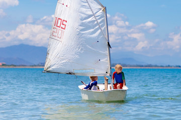 Child sailing. Kid learning to sail on sea yacht.