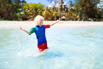 Wall Mural - Kids playing on beach. Children play at sea.