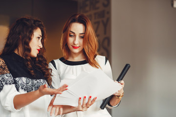 Beautiful girls work in the office. Women communicate.Girls in the office